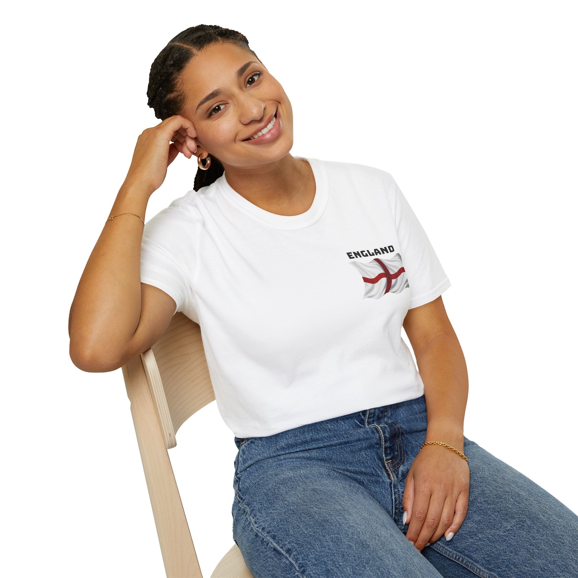 Woman wearing a white t-shirt with 'England' and a flag design, sitting on a chair.