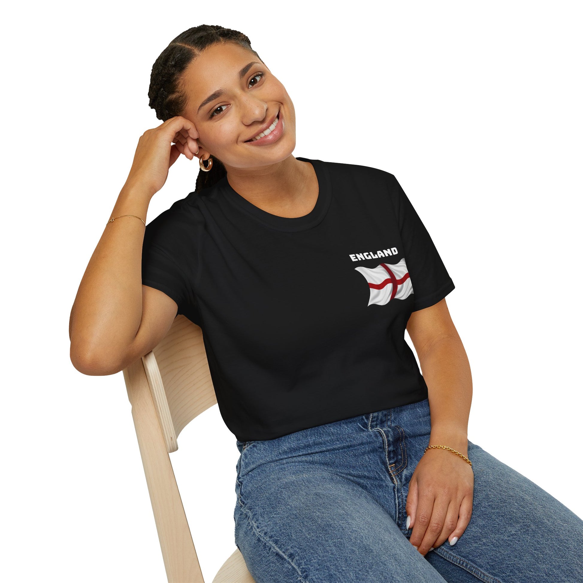Woman wearing a black t-shirt with 'England' and a flag design, sitting on a chair.