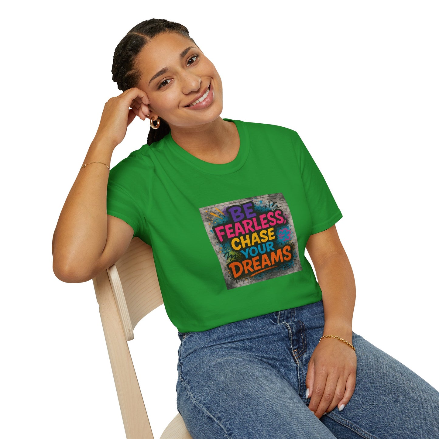 Person wearing a green t-shirt with motivational quote, sitting on a chair.