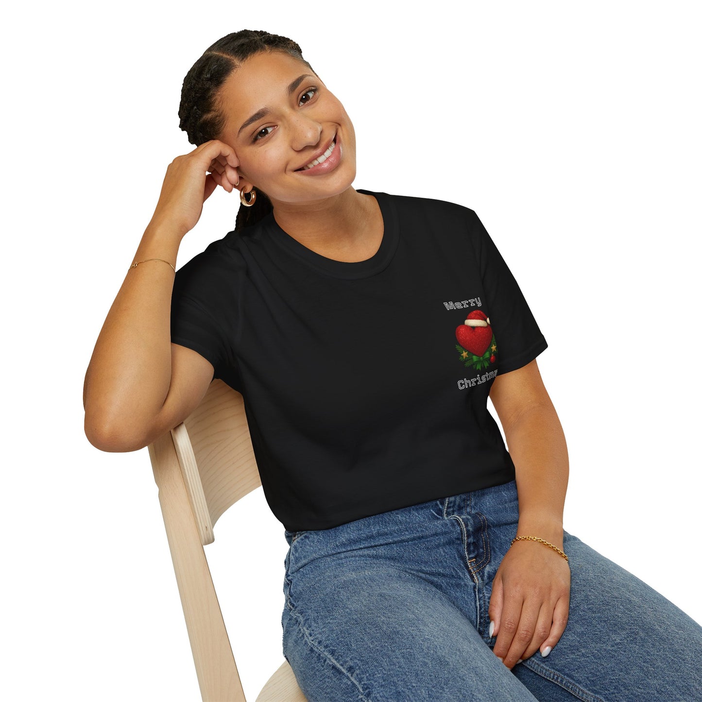 Woman wearing a black t-shirt with a Christmas design, sitting on a chair against a white background