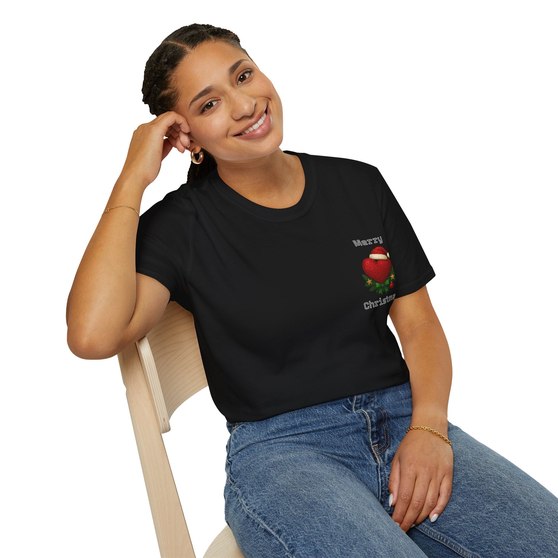 Woman wearing a black t-shirt with a Christmas design, sitting on a chair against a white background