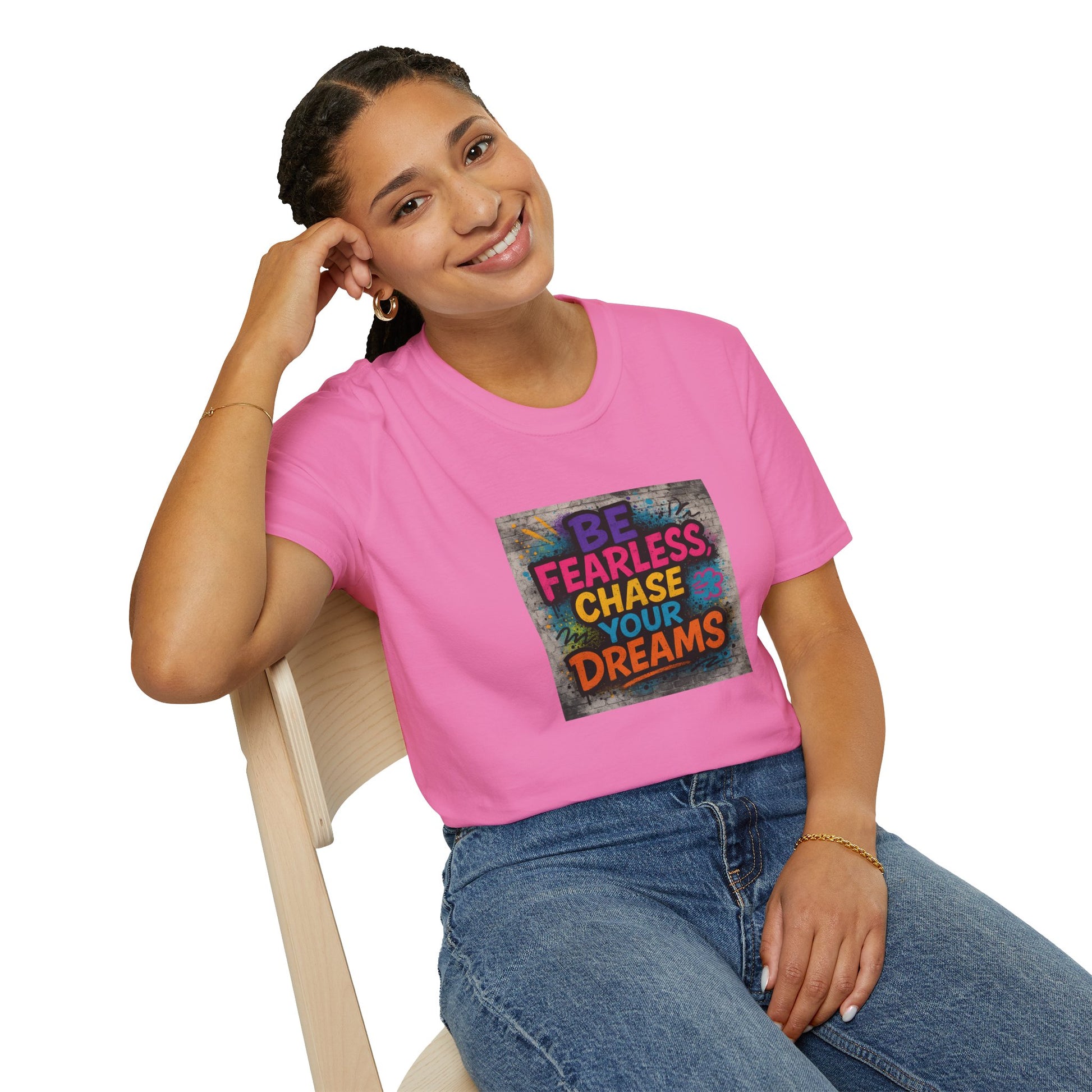Person wearing a pink t-shirt with motivational quote sitting on a chair.