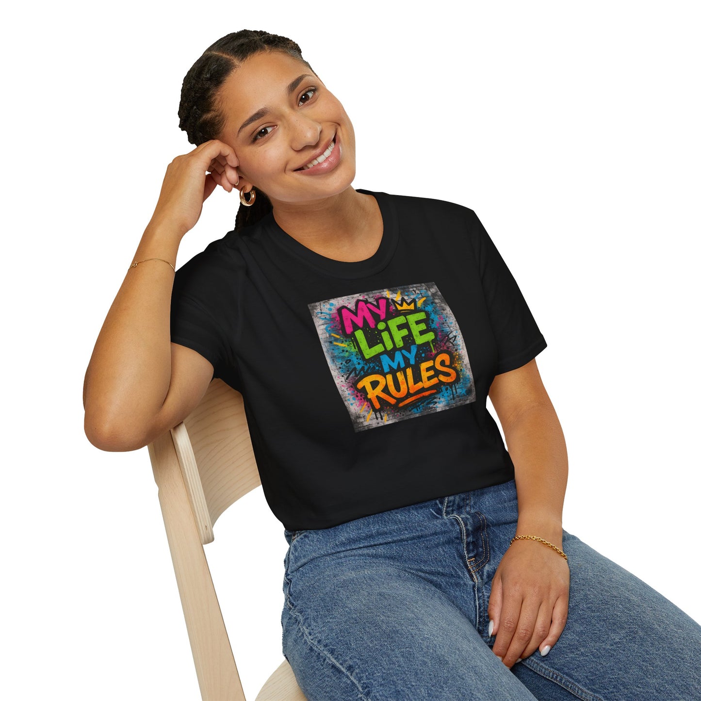 Person wearing a black t-shirt with 'My Life My Rules' design, sitting on a chair.