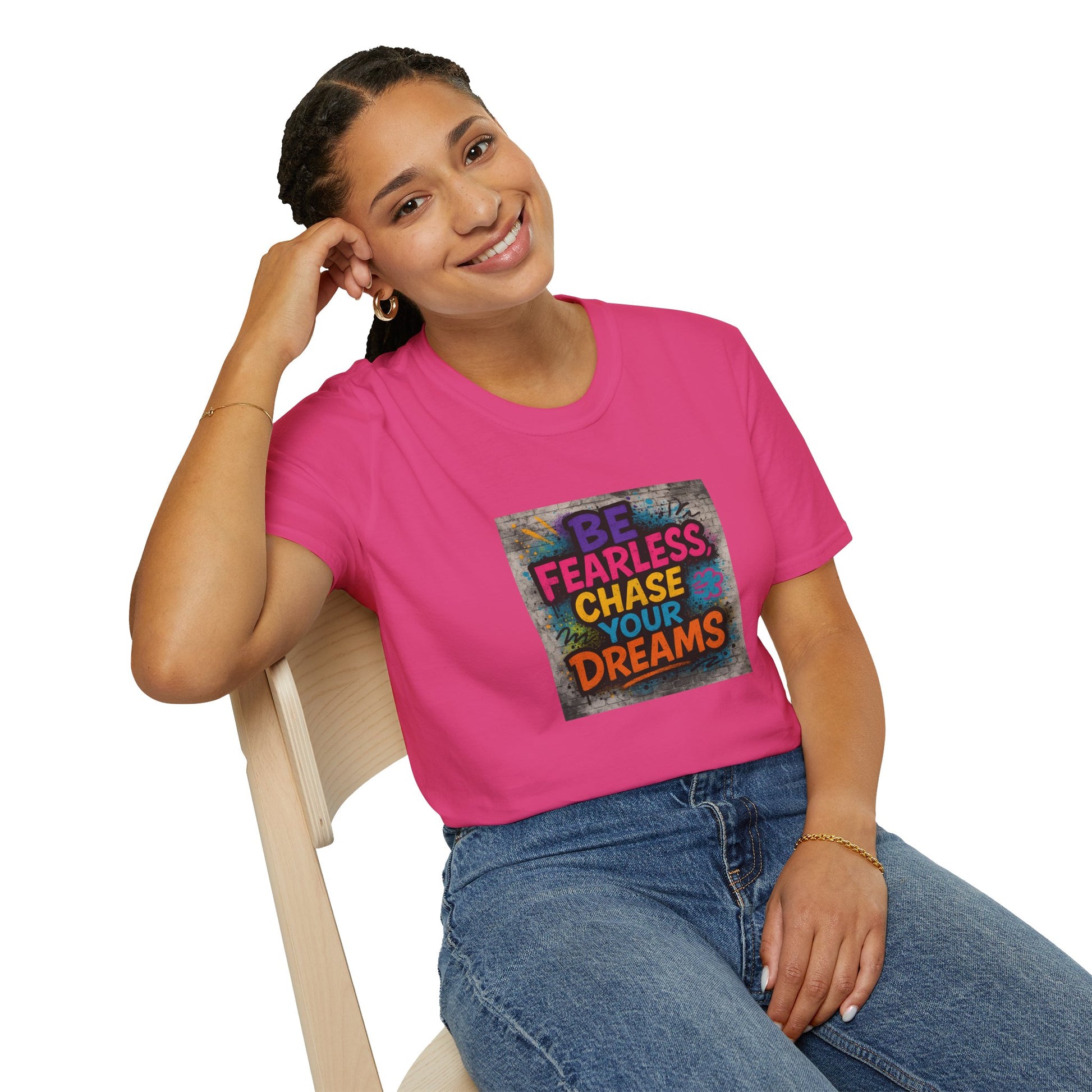 Person wearing a pink t-shirt with motivational quote sitting on a chair.