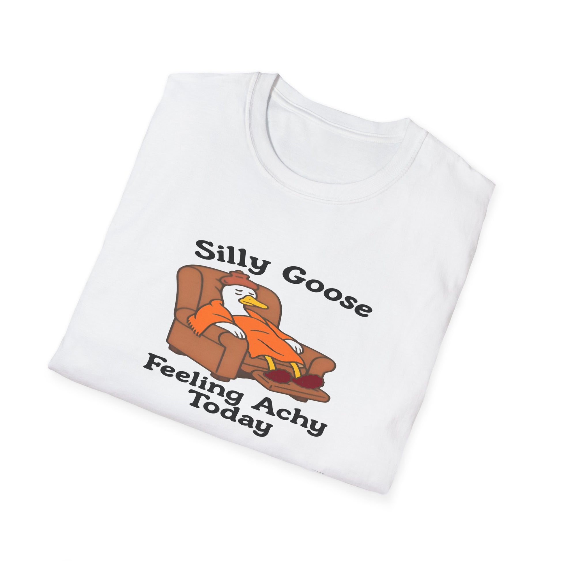 White t-shirt with a cartoon silly goose on a couch and text 'Silly Goose Feeling Achy Today' on a white background