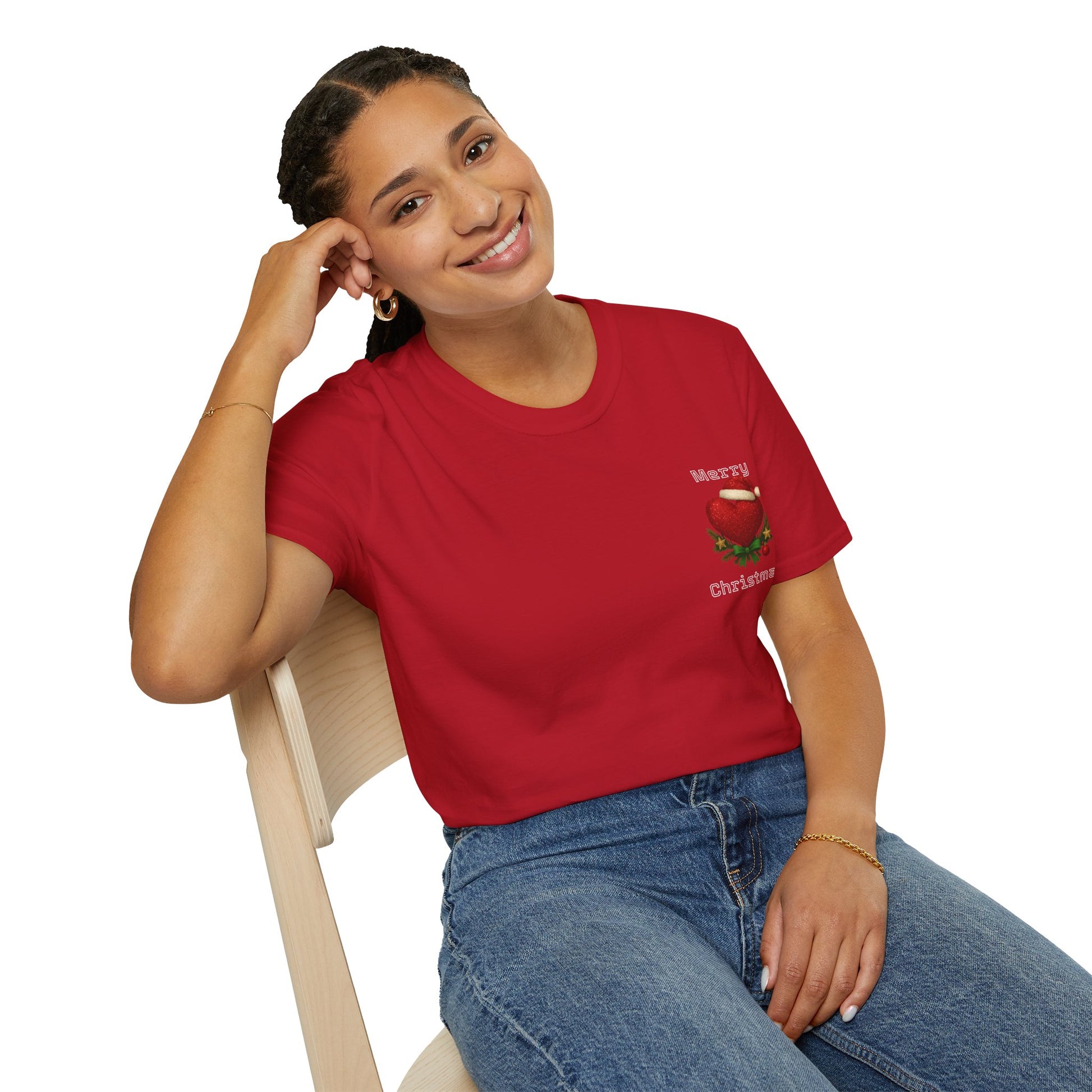 Woman wearing a red heart  t-shirt with a Christmas design, sitting on a chair against a white background