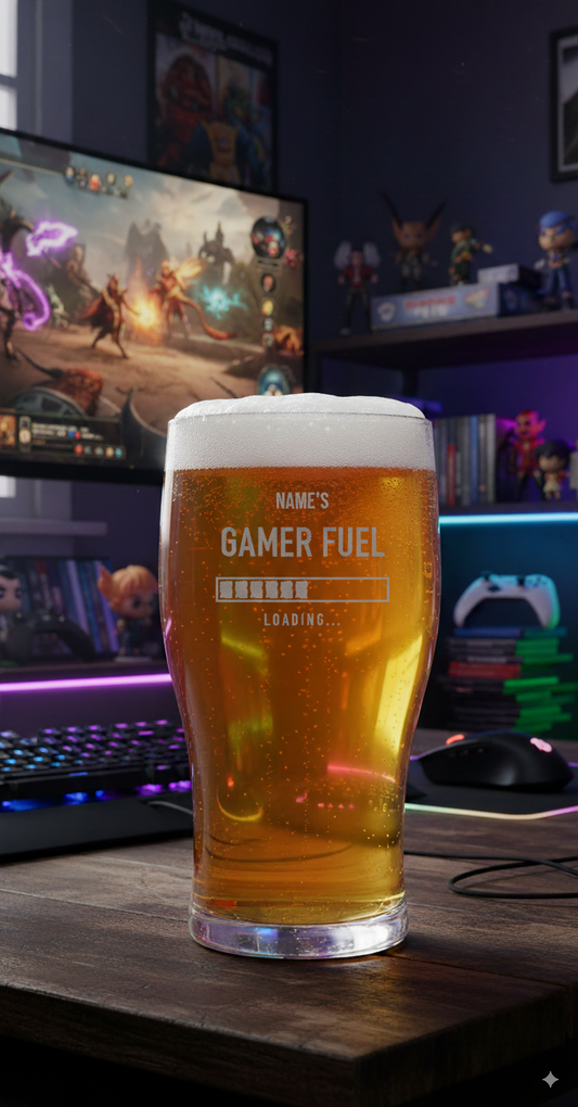 Pint beer Glass of 'Gamer Fuel' in front of a gaming setup with a monitor displaying a game. personalise with name for gift
