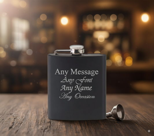 Black hip flask with customizable text on a wooden surface with a blurred bar background