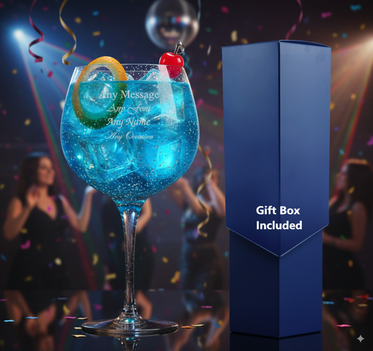 Blue cocktail personalised glass with decorative elements and a gift box on a festive background