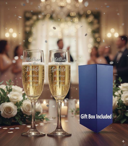 Two champagne flutes with 'Mother , Father of the Bride' engraving next to a blue gift box in a celebratory setting.