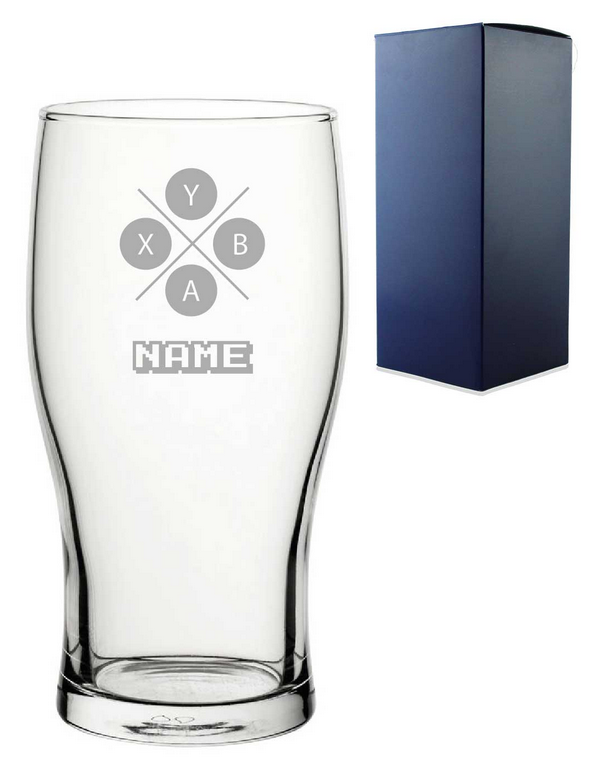 Clear glass gamer glass with engraved design and text next to a blue gift  box on a white background