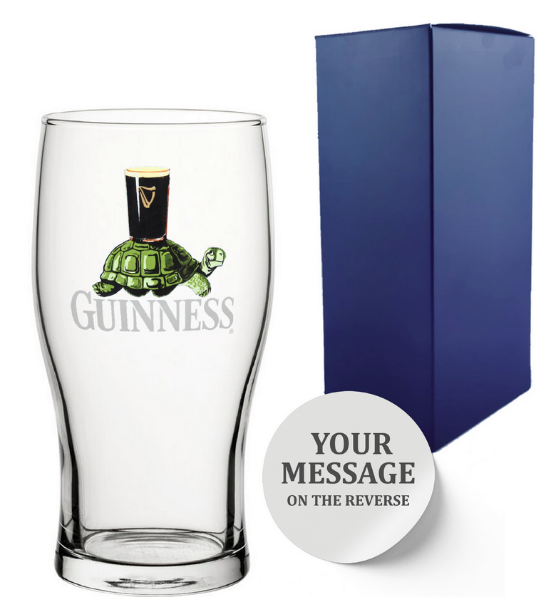 Clear Guinness glass with tortoise design and blue gift box with personalise engraved text on a white background