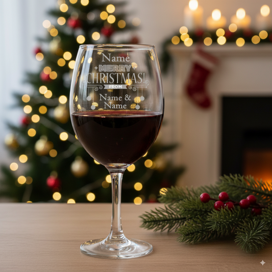 red wine filled engraved merry christmas wine glass